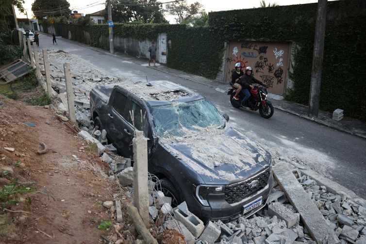 REUTERS/Pilar Olivares/ Proibido reprodução Um veículo está parado entre escombros após um muro desabar durante ventos fortes no Rio de Janeiro, Brasil, em 30 de julho de 2026. REUTERS/Pilar Olivares